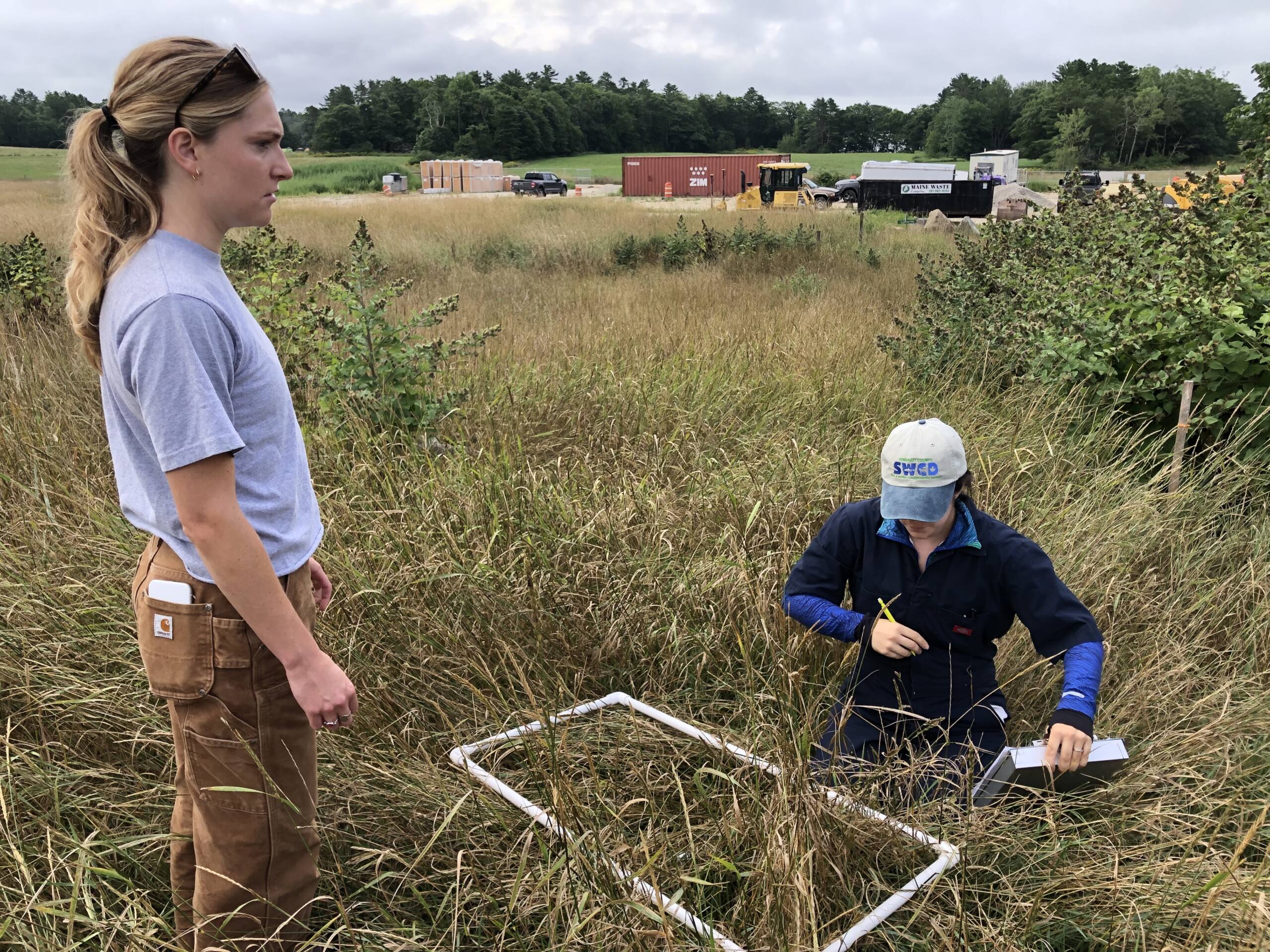 Two farm staffers working out in a field