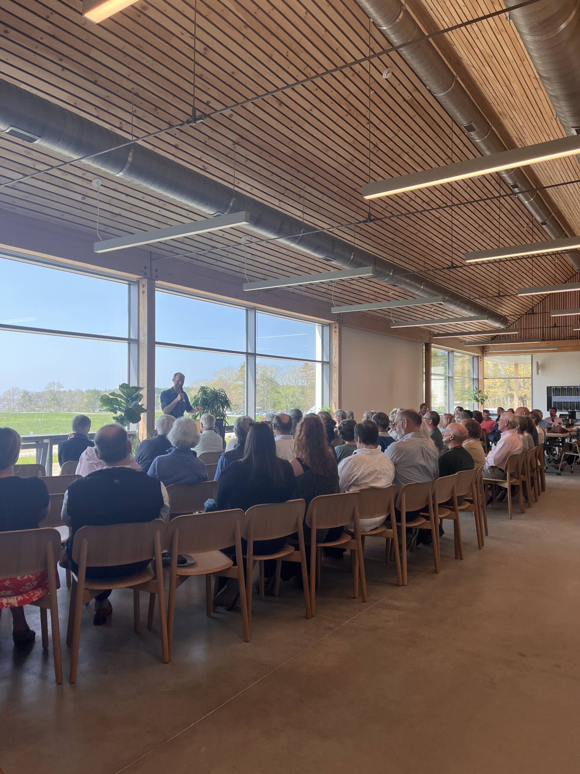 People sitting in chairs listening to a speaker at the Smith Center