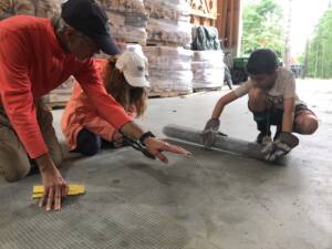 Chris works closely instructing farm campers on a project